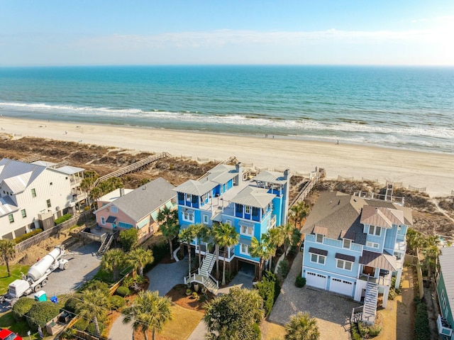 birds eye view of property featuring a view of the beach, a water view, and a residential view