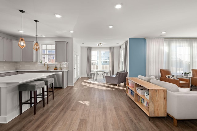 living room with hardwood / wood-style floors and sink