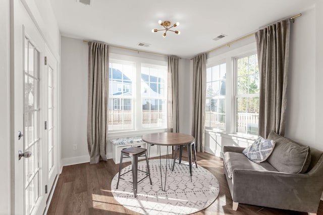 living area featuring dark hardwood / wood-style floors and a notable chandelier