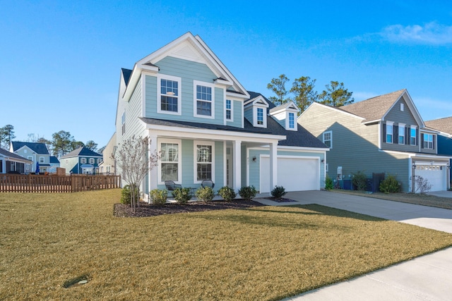 view of front of property with covered porch, a garage, and a front yard