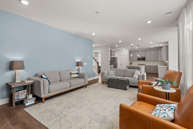 living room featuring hardwood / wood-style flooring and sink