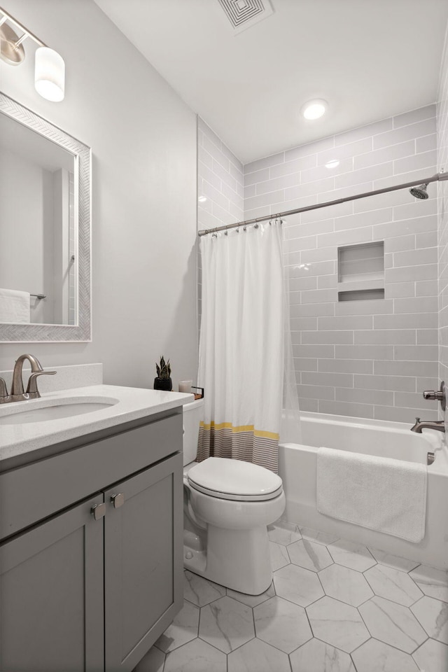 full bathroom with shower / bath combo with shower curtain, vanity, and toilet