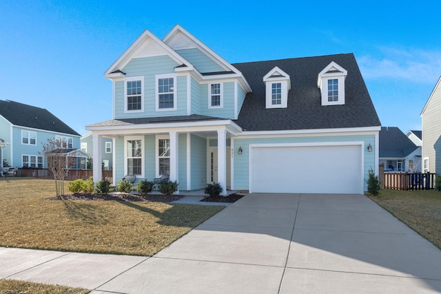 view of front of property featuring a front lawn and a garage