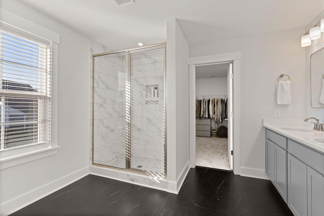 bathroom featuring vanity and a shower with shower door