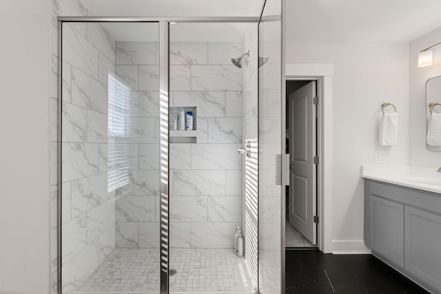 bathroom featuring vanity and a shower with shower door