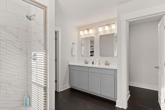 bathroom featuring a tile shower and vanity