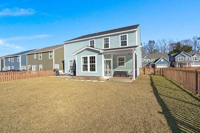 rear view of house featuring a yard