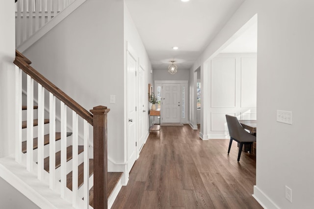 corridor with hardwood / wood-style flooring