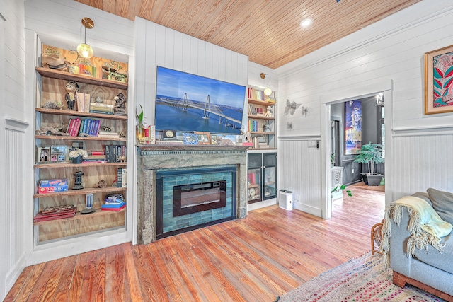 living room with wood ceiling, hardwood / wood-style flooring, and wooden walls