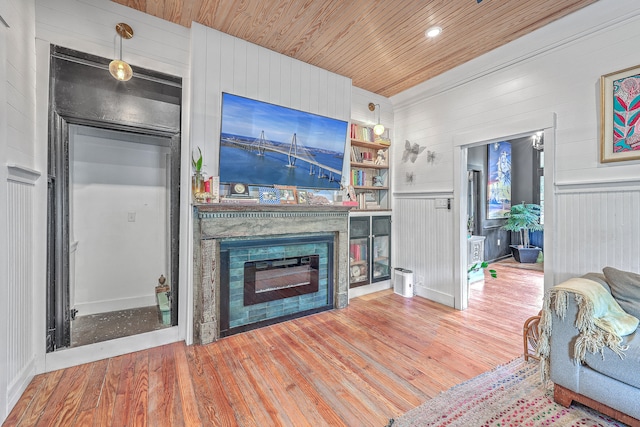 living room featuring wood ceiling, wooden walls, and hardwood / wood-style flooring