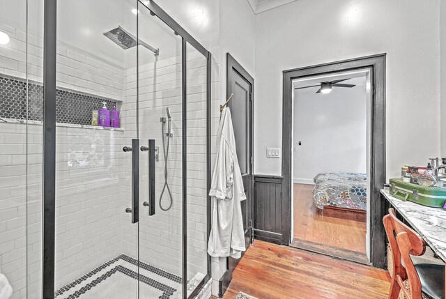 bathroom featuring vanity, hardwood / wood-style floors, and a shower with shower door