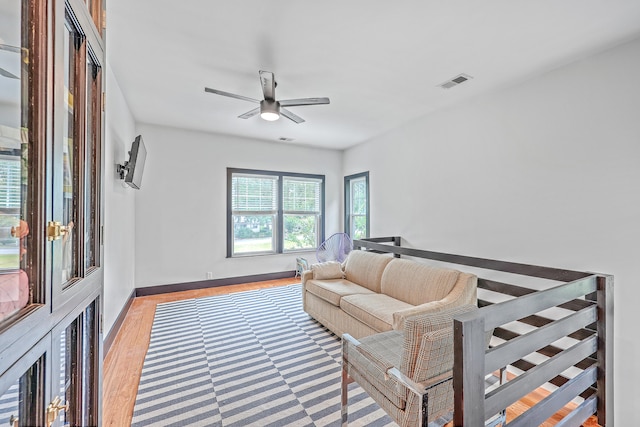 living room with hardwood / wood-style floors and ceiling fan