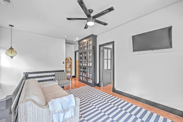 living room with ceiling fan and hardwood / wood-style flooring