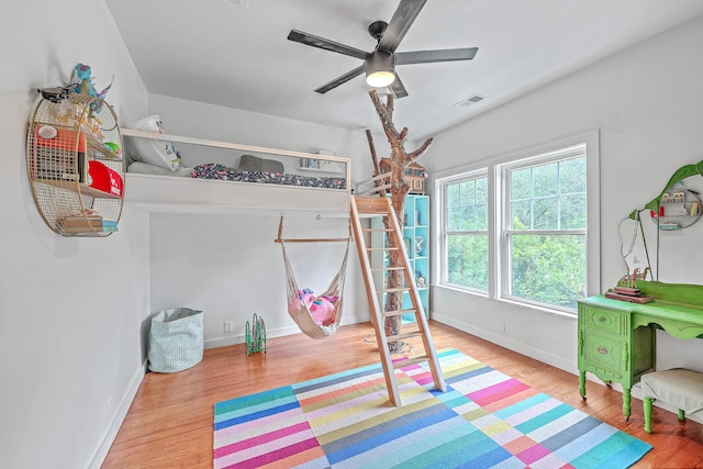 bedroom with ceiling fan and light hardwood / wood-style floors