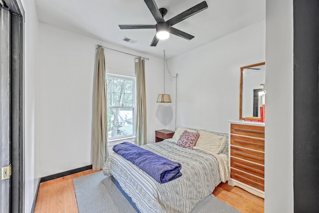 bedroom with light hardwood / wood-style flooring and ceiling fan