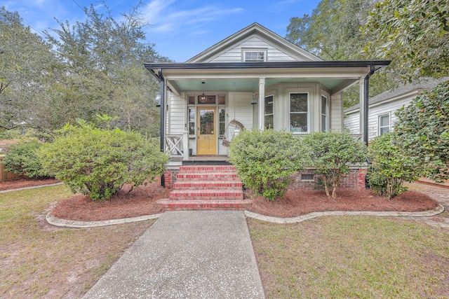 bungalow-style home featuring a front yard and a porch