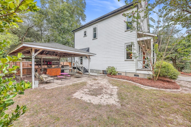 back of property featuring a patio and a gazebo