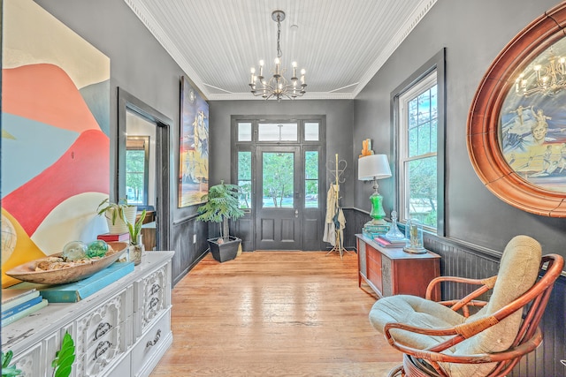 foyer featuring hardwood / wood-style floors, plenty of natural light, and crown molding