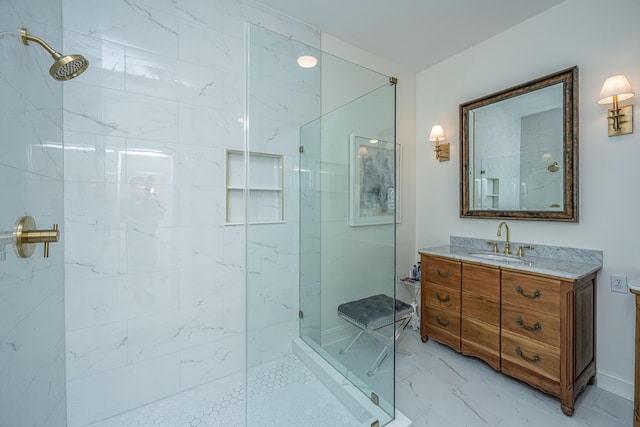 bathroom featuring vanity, a shower stall, and marble finish floor