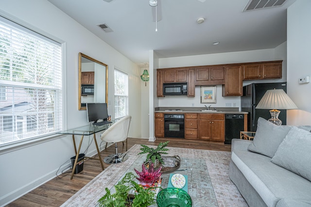 living room featuring a ceiling fan, wood finished floors, and visible vents