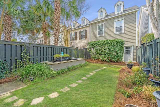 view of yard with a fenced backyard