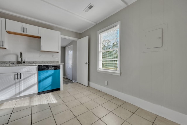 kitchen featuring white cabinets, light tile patterned floors, stainless steel dishwasher, and light stone counters