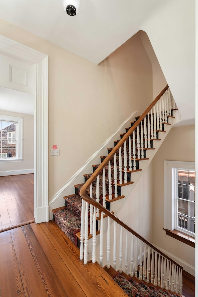 stairs with baseboards and wood-type flooring