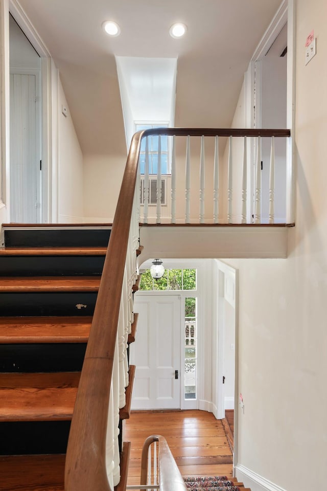 stairs featuring baseboards, recessed lighting, and wood finished floors