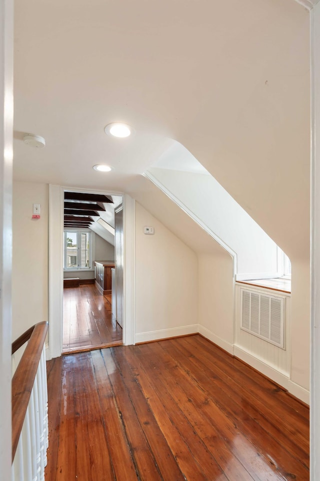 additional living space featuring wood-type flooring, visible vents, baseboards, lofted ceiling, and recessed lighting