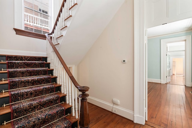 stairs with baseboards and hardwood / wood-style floors