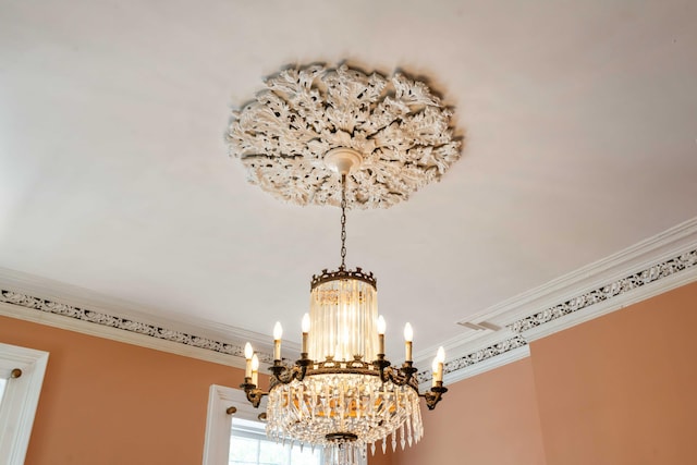 room details with ornamental molding and a notable chandelier