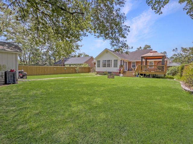 back of property featuring a gazebo, a yard, and a wooden deck