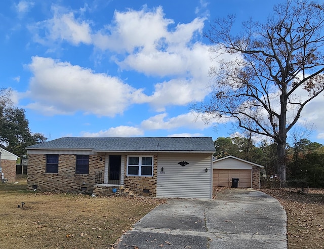 view of front of property featuring a shingled roof, a detached garage, crawl space, an outdoor structure, and brick siding