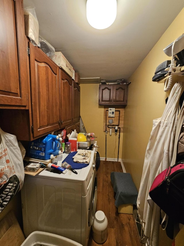 clothes washing area with washer / dryer, cabinet space, baseboards, and dark wood-style floors