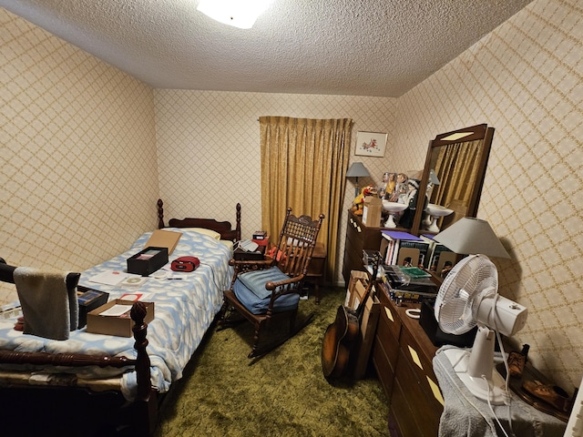 carpeted bedroom with a textured ceiling and wallpapered walls