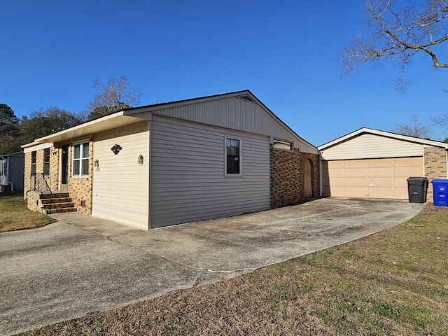 view of side of home with brick siding and an outdoor structure