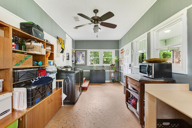 1549 N Avalon Cir, Charleston, SC 29407 - laundry room with ceiling fan, washing machine and clothes dryer, and wood walls