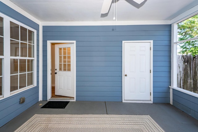 view of exterior entry featuring a ceiling fan