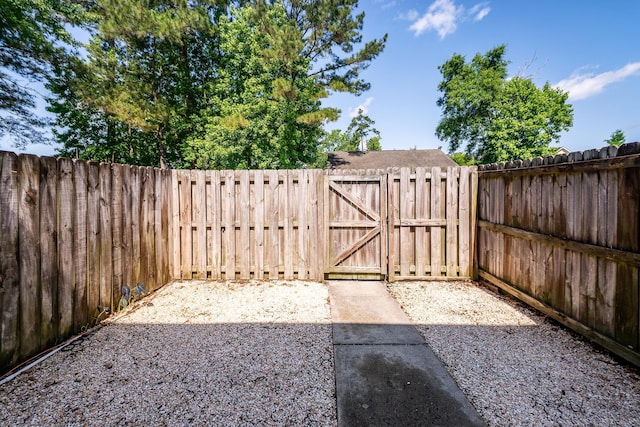 fenced backyard featuring a gate