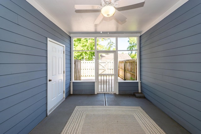 unfurnished sunroom with a ceiling fan
