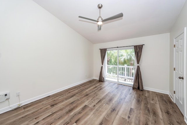 spare room with wood finished floors, ceiling fan, lofted ceiling, and baseboards