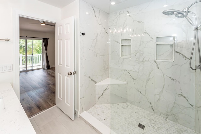 bathroom featuring a marble finish shower and a ceiling fan