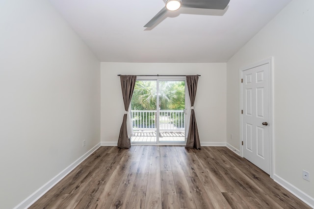 spare room featuring ceiling fan, wood finished floors, and baseboards