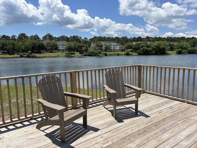 deck featuring a water view and view of scattered trees