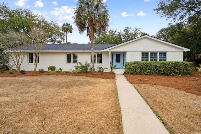 ranch-style house with a front lawn