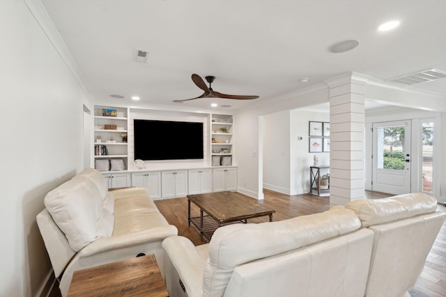 living room with decorative columns, ornamental molding, ceiling fan, and light hardwood / wood-style flooring