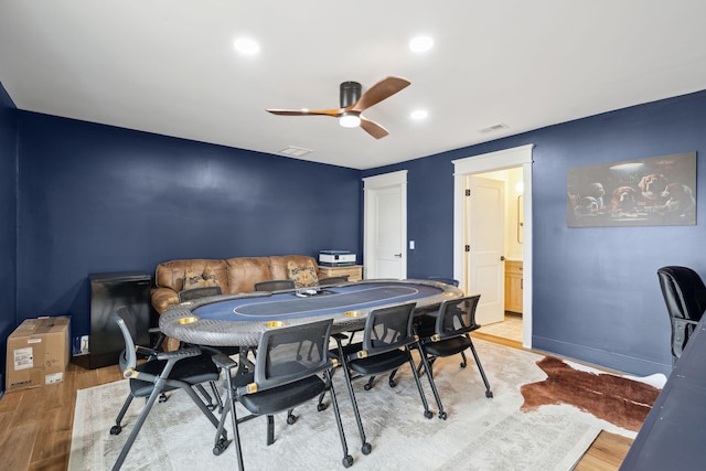 rec room with ceiling fan and light hardwood / wood-style flooring