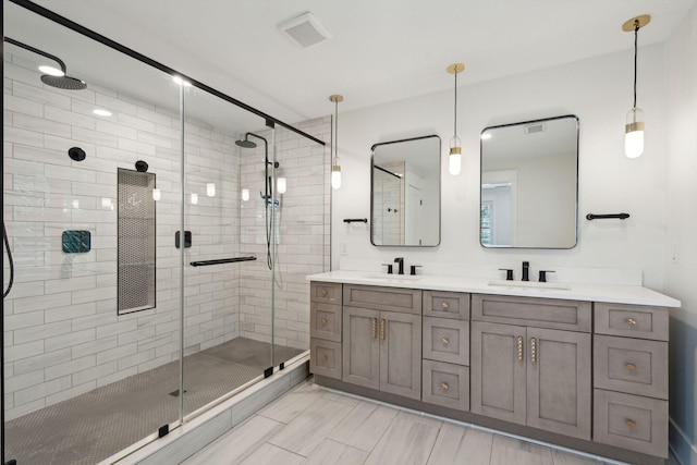 bathroom featuring vanity and a shower with shower door