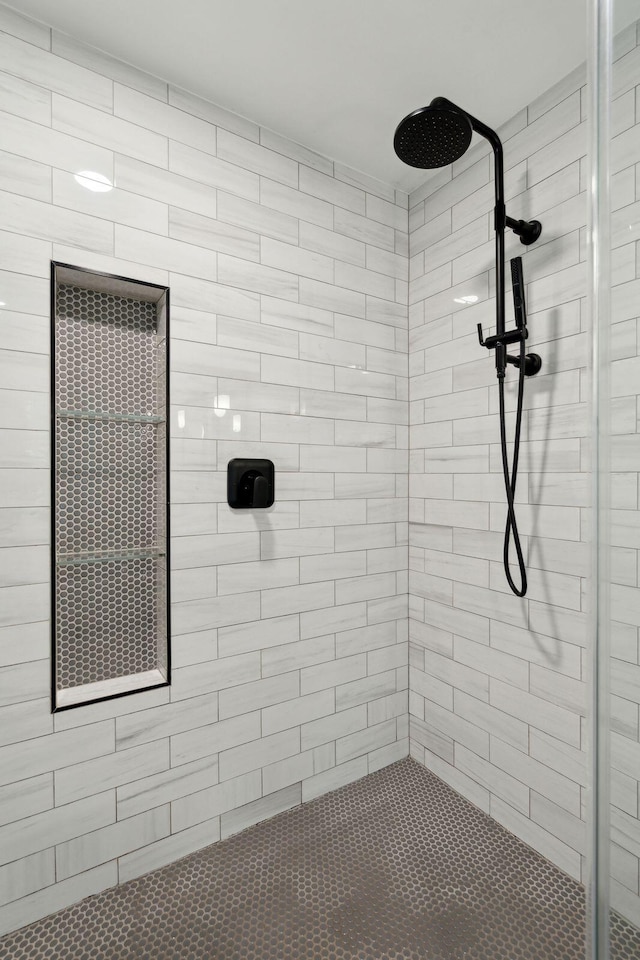 bathroom with tiled shower