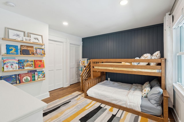 bedroom featuring hardwood / wood-style flooring and multiple windows